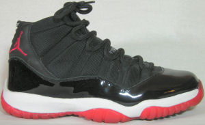 Air Jordan Retro 11 basketball shoe: black, white trim, red trim and JUMPMAN