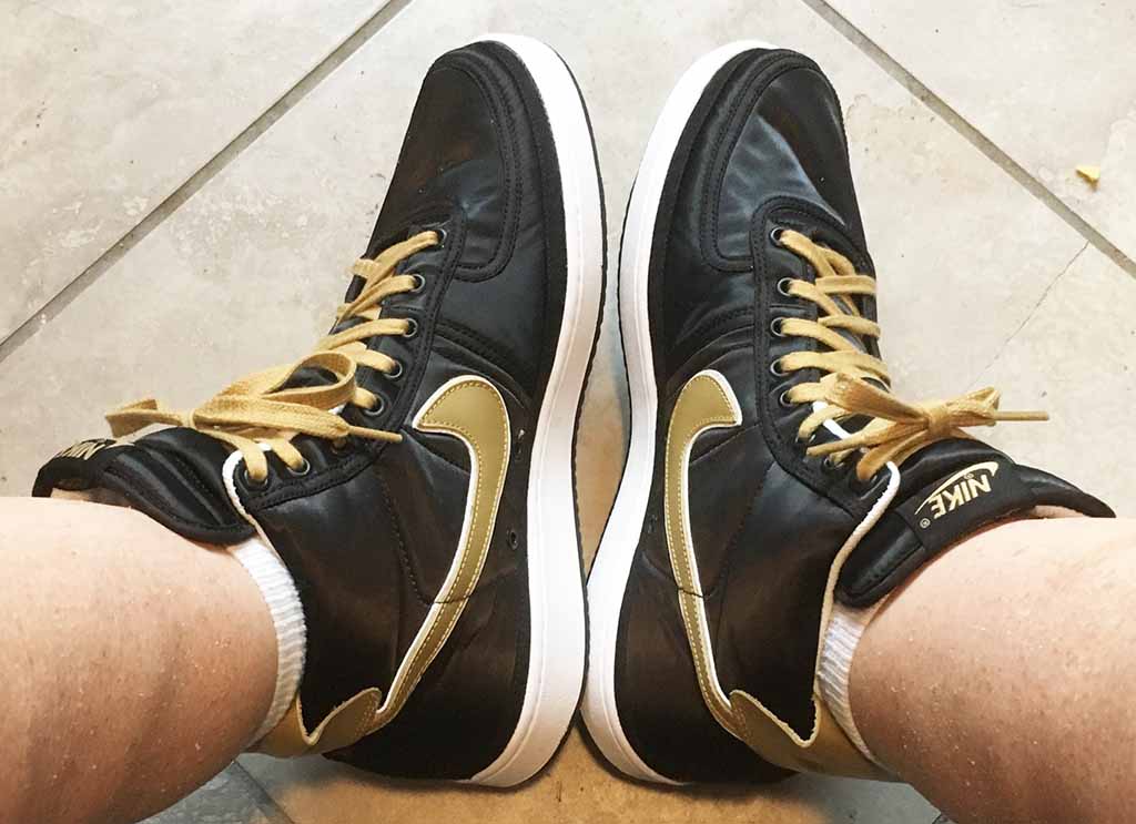 Black Nike Vandal Supreme hightops with gold and white SWOOSH