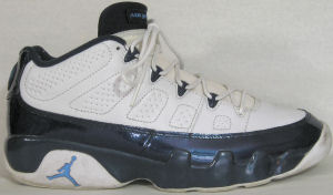 Air Jordan 9 Retro Low basketball shoe in white with black trim and Carolina blue JUMPMAN