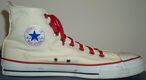 Converse "Chuck Taylor" All Star unbleached white high-top basketball shoe with red laces