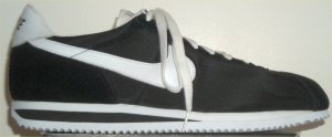 Nike Cortez in black nylon with white SWOOSH and midsole